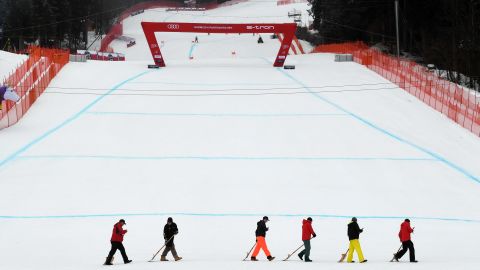 Workers clear the finish line before the men's downhill competition of the Alpine Skiing World Cup in Garmisch-Partenkirchen, Germany on Saturday.