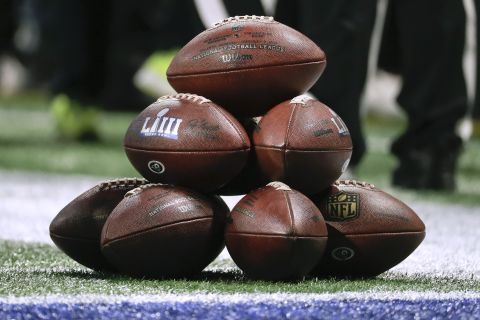Game balls are stacked on the field before the game.