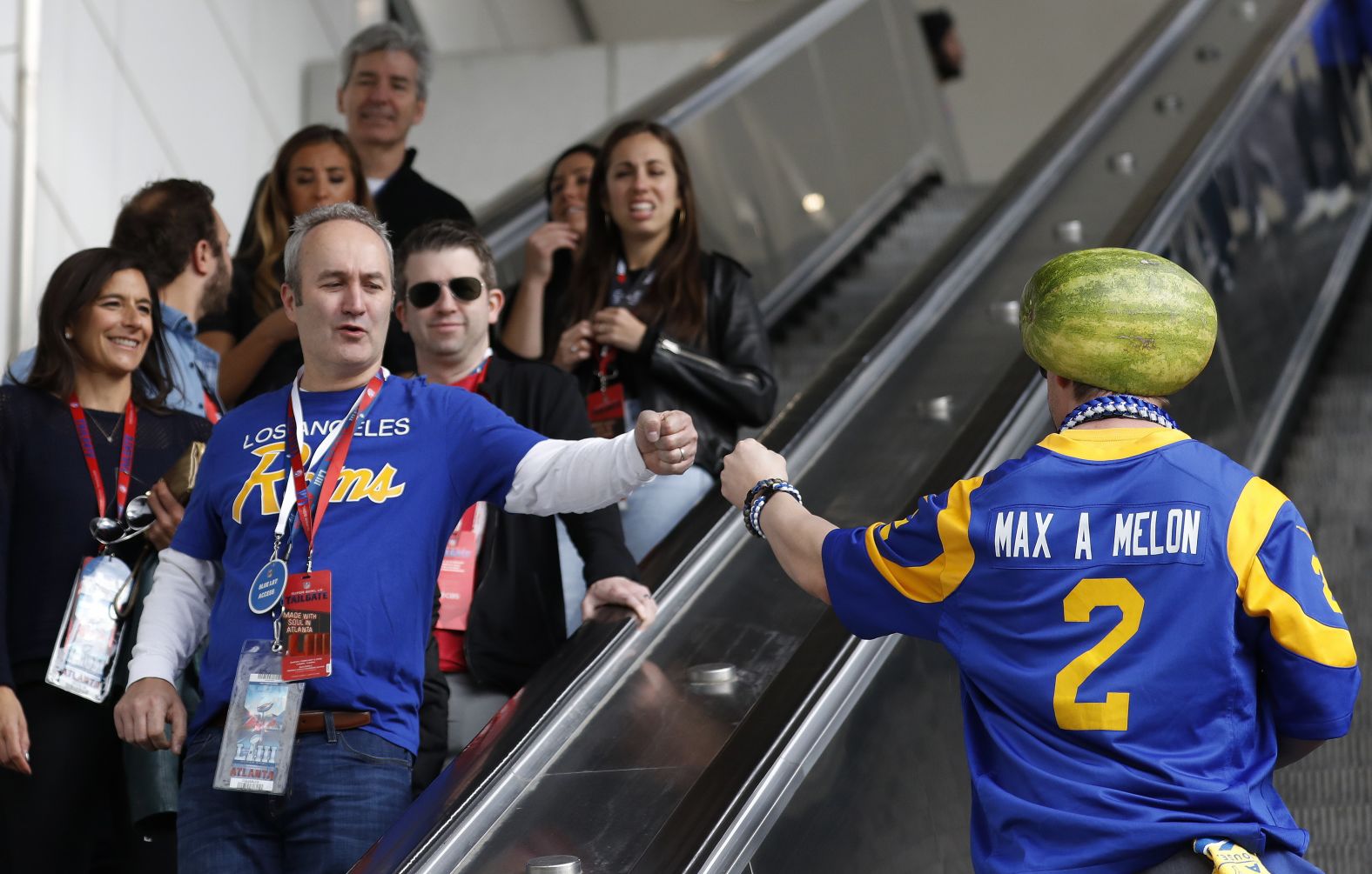 Rams fans give each other a fist bump.