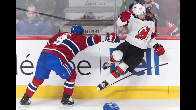 Montreal's Jordie Benn, left, collides with New Jersey's Brett Seney during an NHL hockey game in Montreal on Saturday, February 2.