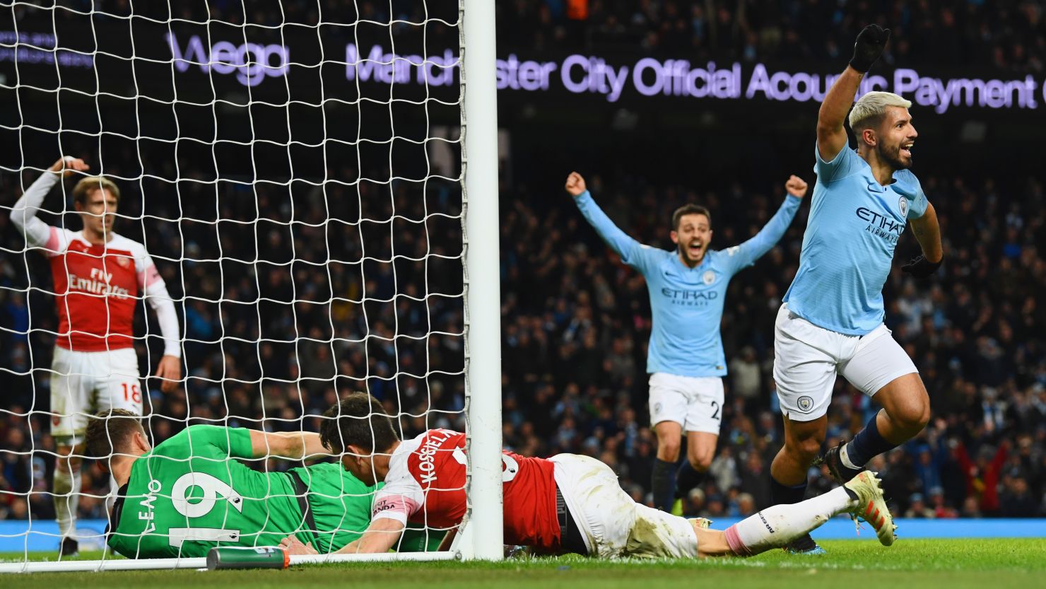 Sergio Aguero of Manchester City (right) celebrates after scoring his team's third goal during the Premier League match between Manchester City and Arsenal FC at Etihad Stadium on Sunday.  Aguero has scored 219 career goals for City, a team record. 