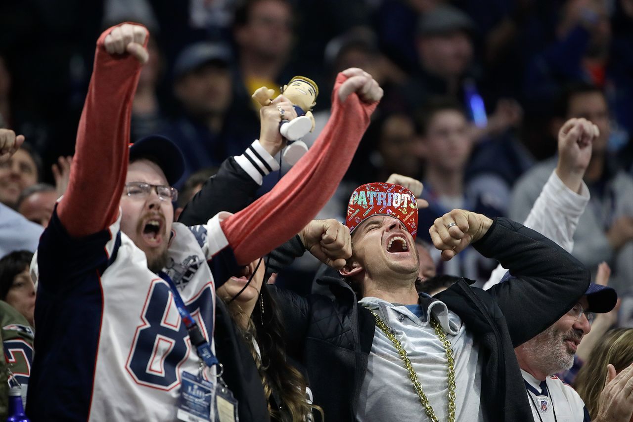 Patriots fans cheer during the second half.