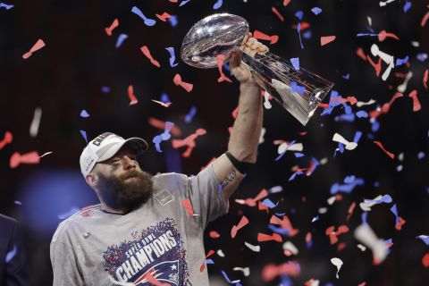 Patriots wide receiver Julian Edelman, the game's Most Valuable Player, holds up the Lombardi Trophy.