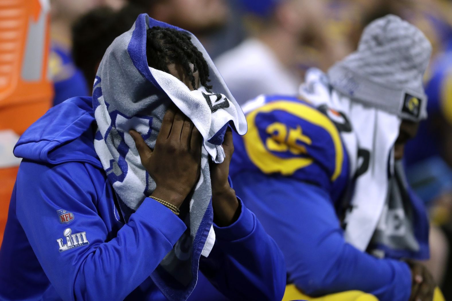 Rams players sit dejected on the bench.