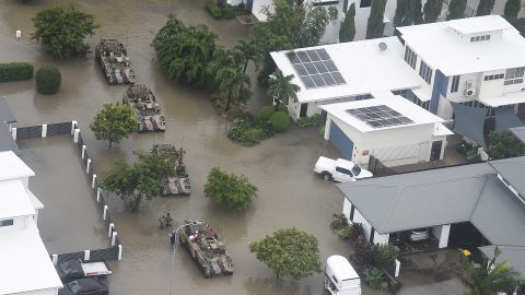 Army members assist residents in flooded Townsville on Monday.