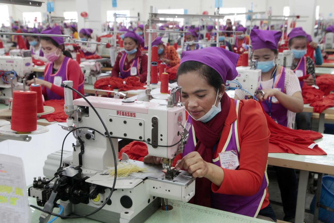 Garment workers sew clothes in a factory  outside of Phnom Penh, Cambodia, on August 30, 2017.  