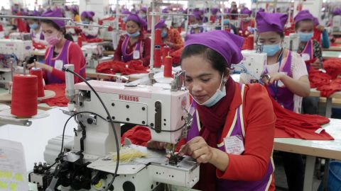 Garment workers sew clothes in a factory outside of Phnom Penh, Cambodia, on August 30, 2017.