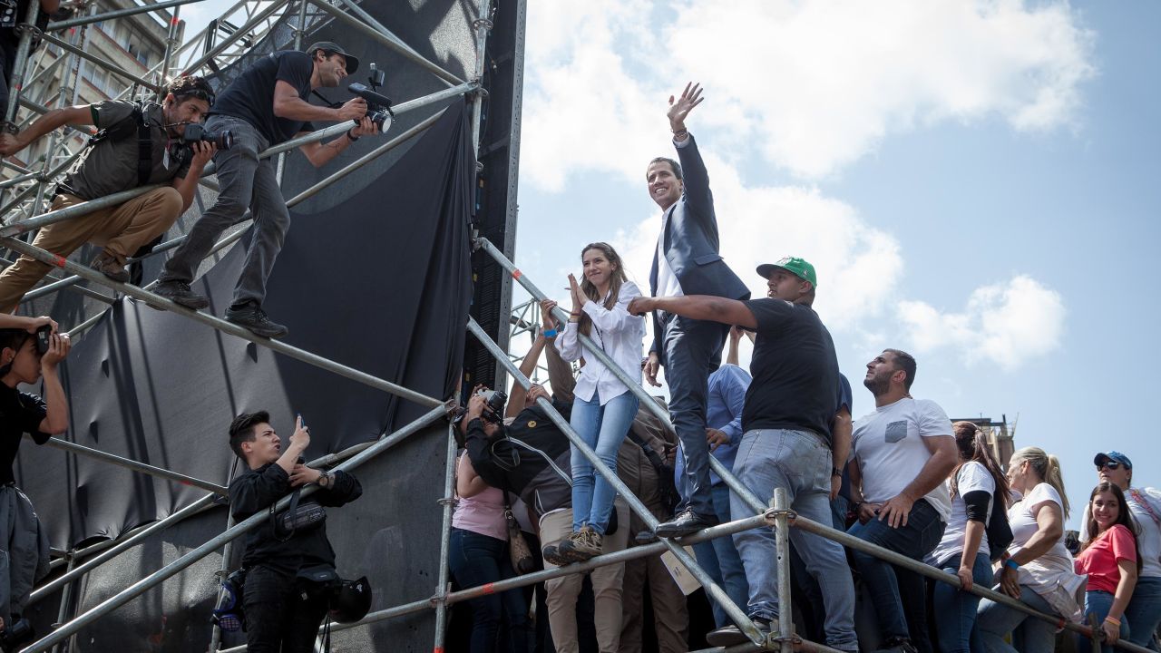 Juan Guaido waves to thousands of his at a rally in the capital Caracas on Saturday.