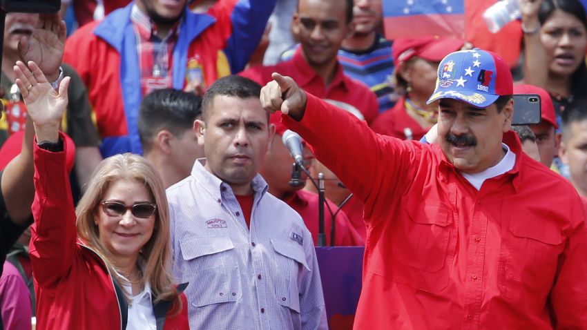 President Nicolas Maduro and first lady Cilia Flores greet supporters as they arrive at a rally in Caracas, Venezuela, Saturday, Feb. 2, 2019. Maduro called the rally to celebrate the 20th anniversary of the late President Hugo Chavez's rise to power. (AP Photo/Ariana Cubillos)