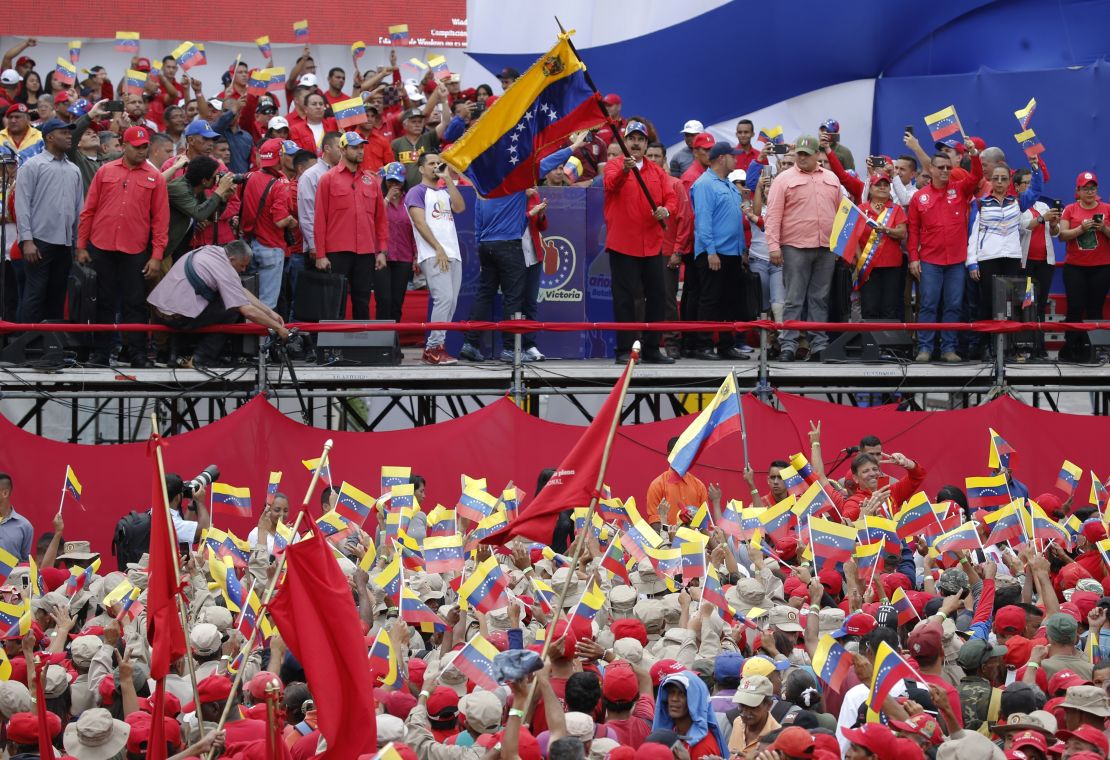 Venezuela's President Nicolas Maduro waves a national flag during a rally in Caracas, Venezuela, Saturday, Feb. 2, 2019.