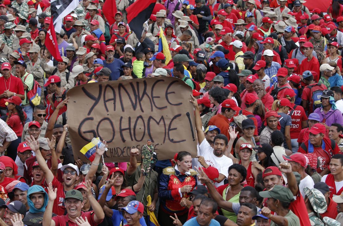 Supporters of President Nicolas Maduro hold up an anti-American banner during a rally in Caracas, Venezuela, Saturday, Feb. 2, 2019. 