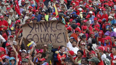 Supporters of President Nicolas Maduro hold up an anti-American banner during a rally in Caracas, Venezuela, Saturday, Feb. 2, 2019.