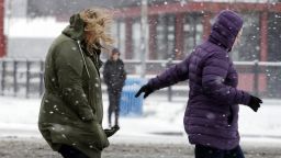 Pedestrians huddle against snow and a cold wind Monday morning, Feb. 4, 2019, in Seattle. Western Washington was hit by a major winter storm, with several inches of snow, cold temperatures and bone-chilling winds overnight and into the day Monday. Numerous school districts have closed for the day and temperatures were in the low 20s across much of the region with wind chills in the teens. (AP Photo/Elaine Thompson)