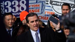 New York State Sen. Michael Gianaris, center, calls on supporters to remove the Amazon app from their phones and boycott the compony, as he address a coalition rally and press conference Wednesday Nov. 14, 2018, in New York. (AP Photo/Bebeto Matthews)