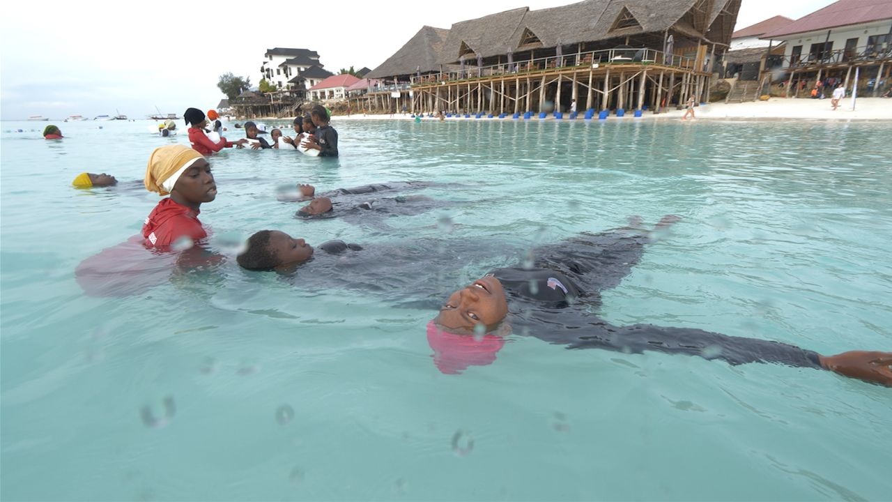 Girls practicing swimming styles in Zanzibar island