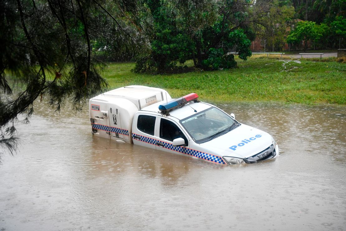 A police car is seen partially submerged in a drain after being swamped by flood waters on February 05, 2019 in Townsville, Australia.