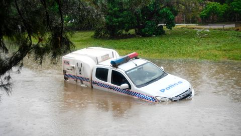 A police car is seen partially submerged in a drain after being swamped by flood waters on February 05, 2019 in Townsville, Australia.