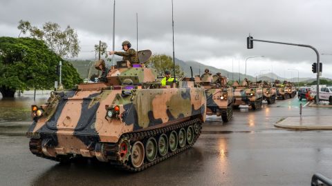 Army vehicles enter Townsville to help evacuate flood-affected people on February 4, 2019.