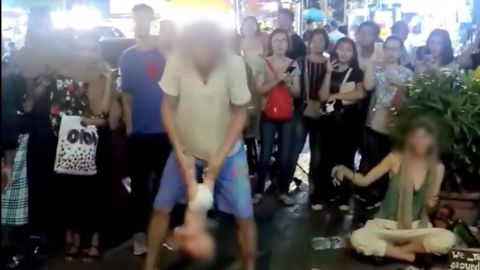 The Russian group played instruments and chanted while one member swung the infant around repeatedly.
