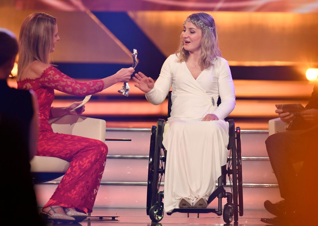 Vogel receives her award at the German athlete of the year ceremony from TV presenter  Katrin Mueller-Hohenstein.