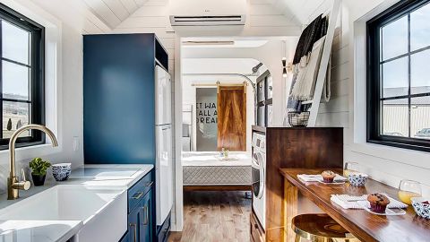 The 'tiny home' has a living room, bathroom, bedroom, and kitchen area that customers can explore.