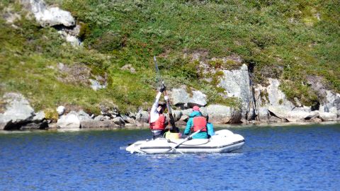 Yarrow Axford's team recovers a surface sediment core from a south Greenland lake.