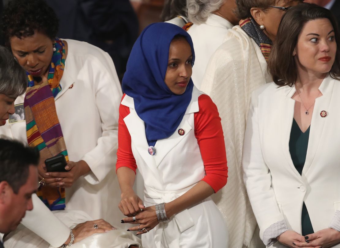 Rep. Ilhan Omar of Minnesota wore a white vest and trousers paired with a blue hijab and red shirt.