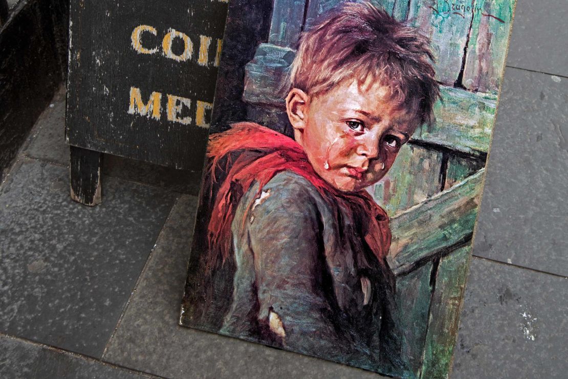 A painting of "The Crying Boy" by Bruno Amadio/Giovanni Bragolin, c.1950s outside an antique shop in Edinburgh.