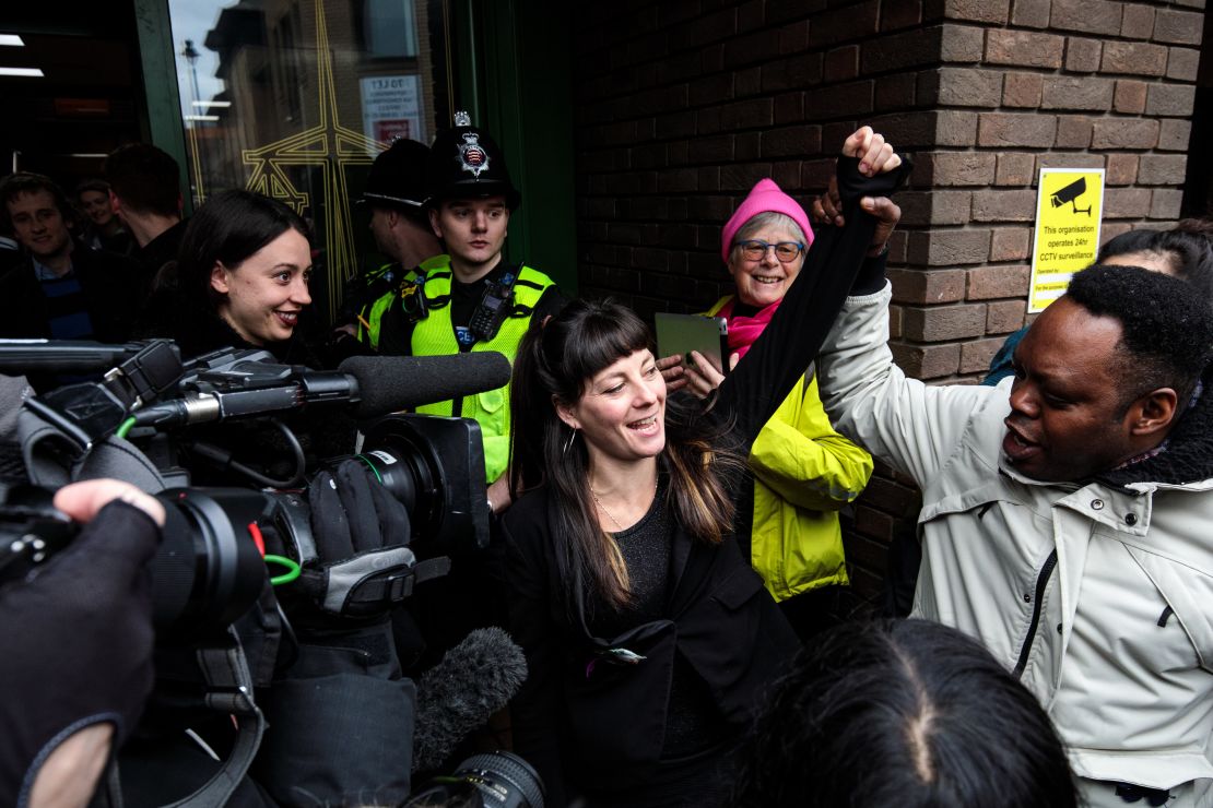 May MacKeith, a member of the so-called 'Stansted 15' raises a fist as she leaves Chelmsford Crown Court.