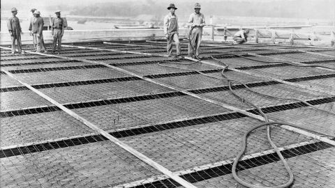 In the New Deal, unemployed workers were given jobs in public works projects like this one to build the Wilson Dam across the Tennessee River.