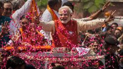 VADODRA, INDIA - APRIL 09:  Supporters throw flower petals as Bharatiya Janata Party (BJP) leader Narendra Modi rides in an open jeep on his way to file nomination papers on April 9, 2014 in Vadodra, India.  India is in the midst of a nine-phase election from April 7-May 12.  (Photo by Kevin Frayer/Getty Images)