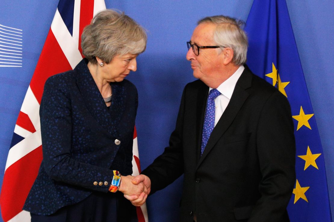 President of the European Commission Jean-Claude Juncker greets UK Prime Minister Theresa May in Brussels on Thursday.