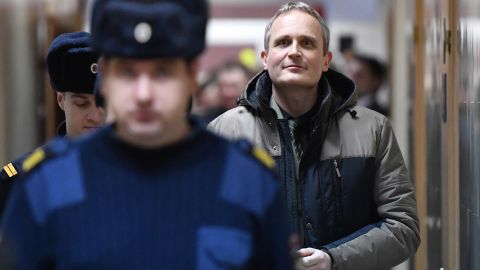 Dennis Christensen, a Jehovah's Witness, is escorted at a courthouse Wednesday in Oryol, Russia. 