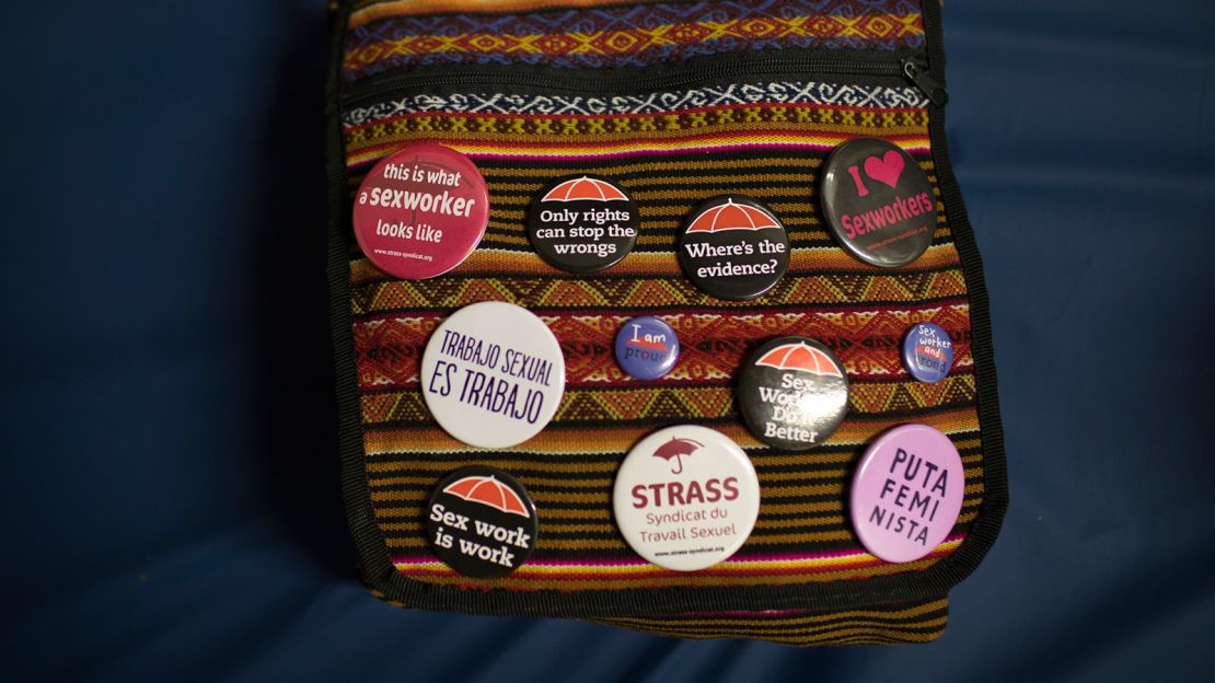 Sex worker buttons decorate Foxxy Angel's handbag.