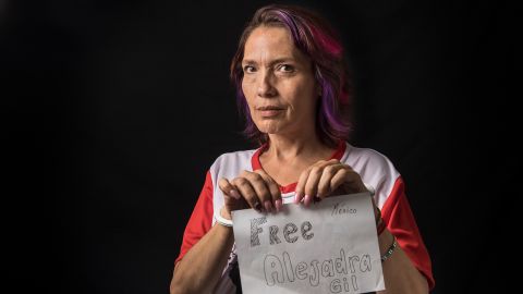 Cynthia Navarrete, 52, holds up a sign that says "Free Alejandra Gil," her mother, who she believes was unfairly arrested for trafficking. She works as a sex worker on the streets in Mexico City and says she likes it because she can choose when to work.