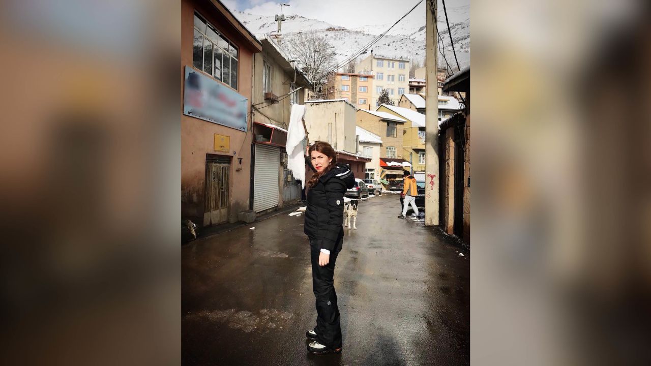 Shaparak Shajarizadeh stands unveiled in an Iranian town waving a white scarf on a stick, as part of the anti-compulsory hijab protests of 2018.