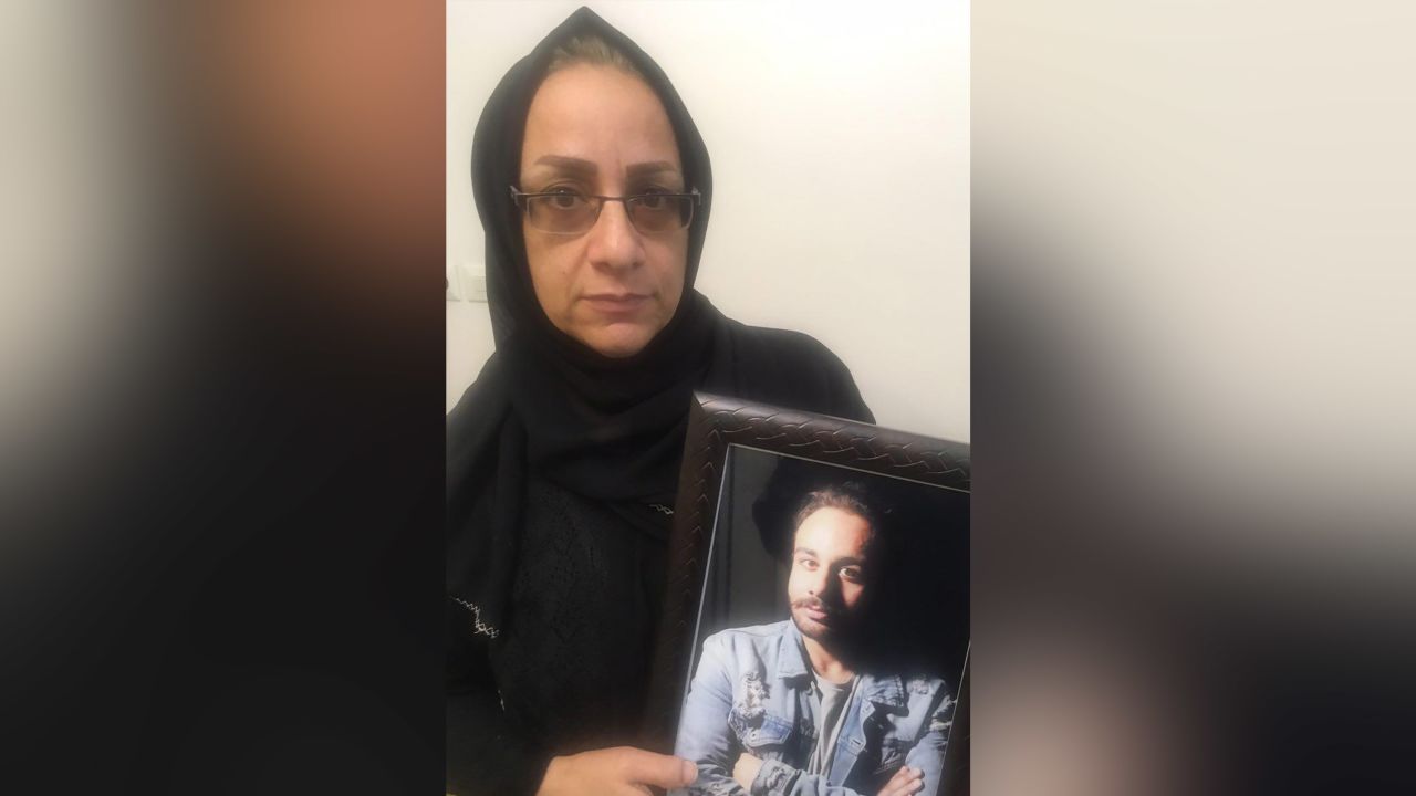 Fatemeh Malayan Nejad holds a picture of her son Sina, who was detained for protesting and died after five days in custody. Courtesy of Fatemeh Malayan Nejad/Masih Alinejad