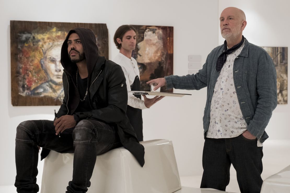Daveed Diggs and John Malkovich as two artists at different stages of their careers, awed by Dease in "Velvet Buzzsaw."