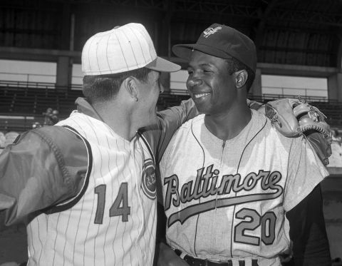 Robinson is greeted by former teammate Pete Rose after being traded to Baltimore before the 1966 season.