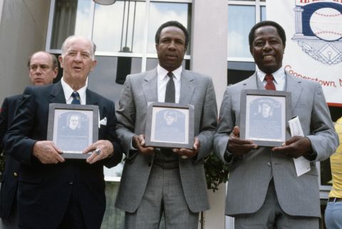 Robinson, center, is joined by Albert "Happy" Chandler, left, and Hank Aaron after they were inducted into the Baseball Hall of Fame in 1982.
