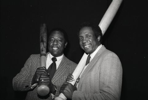Aaron, left, and Robinson pose with oversized bats after being elected to the Hall of Fame.
