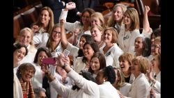 TOPSHOT - Congresswomen, dressed in white in tribute to the women's suffrage movement, pose for a photo as they arrive for the State of the Union address at the US Capitol in Washington, DC, on February 5, 2019. (Photo by SAUL LOEB / AFP)        (Photo credit should read SAUL LOEB/AFP/Getty Images)