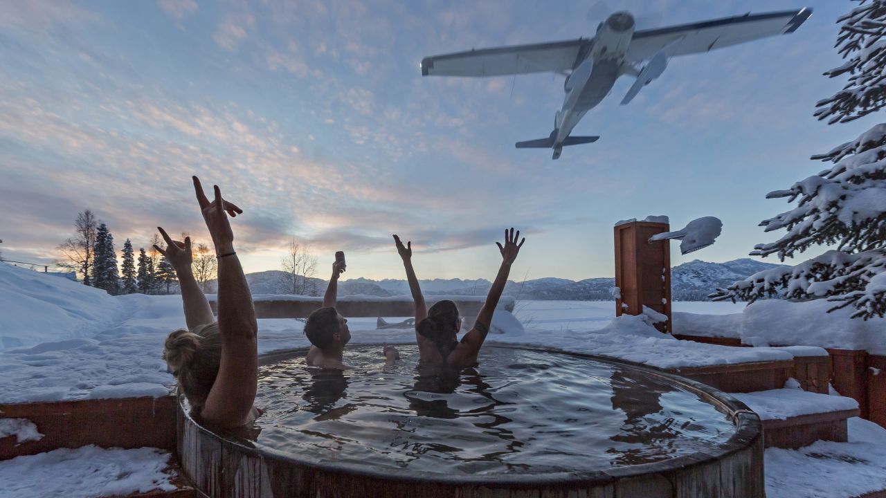 Skiers cheer a flyover from the hot tub at the Tordrillo Mountain Lodge Après-ski.