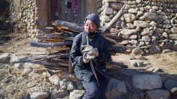 68-year-old Qin Taixiao gathers two bundles of wood every day from a nearby forest to save on heating costs.