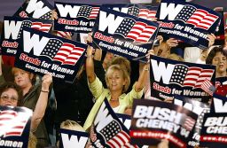 Women cheer on US President George W. Bush as he arrives to deliver remarks on September 17, 2004, during a "Focus On Women's Issues" event in Charlotte, North Carolina.