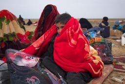 Boys huddle under blankets provided by the Syrian Democratic Forces.