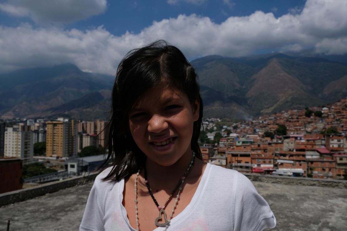 Rosbelis, 12, wants to escape the hunger and violence of Petare and become a photographer. 
