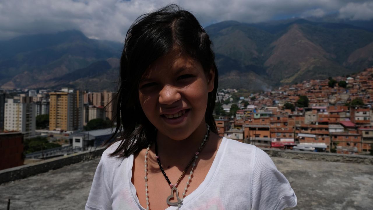 Rosbelis, 12, wants to escape the hunger and violence of Petare and become a photographer. 