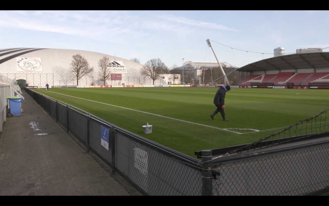 A groundsman prepares a pitch at Ajax's training ground.