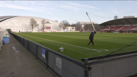 A groundsman prepares a pitch at Ajax's training ground.